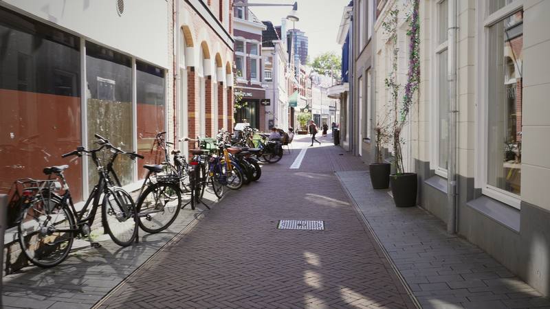 Bicycles parked along a quiet lane in a Dutch old town.